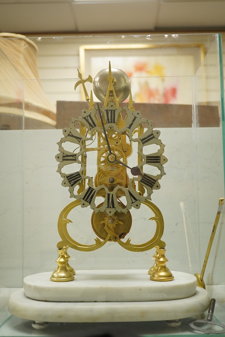 A brass framed skeleton clock, with white marble stand, in glass case, case 39.5cm high
